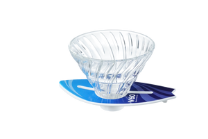 V60 dripper positioned on cyan-to-navy surfboard stand, three-quarter angle view.