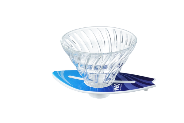 V60 dripper positioned on cyan-to-navy surfboard stand, three-quarter angle view.