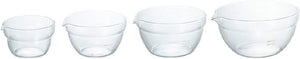 Four glass mixing bowls with pouring spouts displayed in a row showing the complete set size range from small to extra large.
