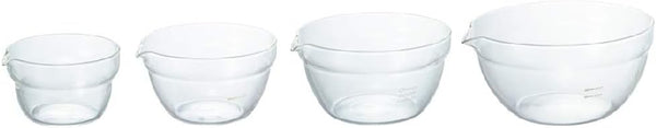 Four glass mixing bowls with pouring spouts displayed in a row showing the complete set size range from small to extra large.