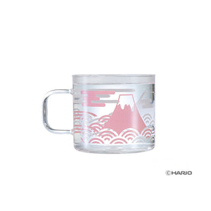 Clear glass mug with Mount Fuji illustration in pink and wavy cloud pattern design.