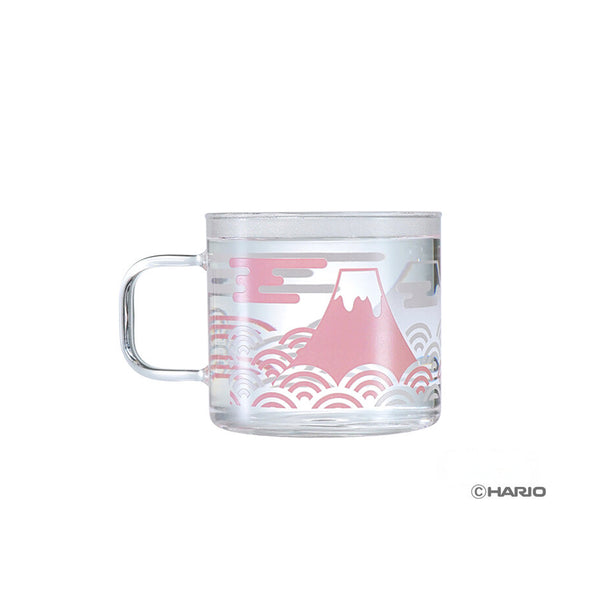 Clear glass mug with Mount Fuji illustration in pink and wavy cloud pattern design.