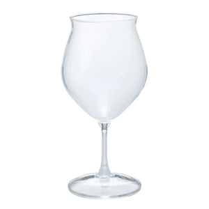 Empty clear glass tulip-shaped tumbler with heat-resistant design on white background.