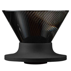 Black V60 dripper displaying interior rib structure with light reflecting off textured walls.