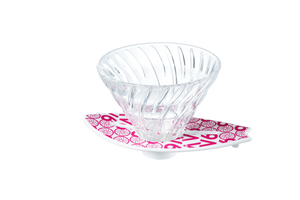 V60 dripper on magenta surfboard base featuring ornamental swirl pattern throughout.