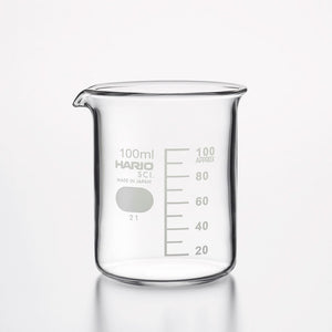 Empty 100ml HARIO glass beaker with volume measurements on white.