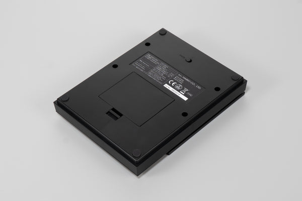 Back view of black Polaris scale showing battery compartment and regulatory markings