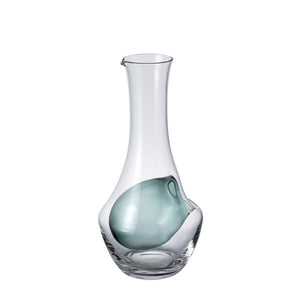 Clear glass carafe with turquoise ice well chamber and integrated handle detail, product shot.