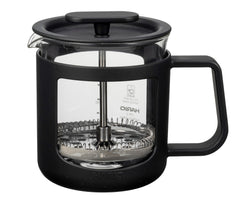 Black Hario coffee press with glass carafe and metal plunger shown front view on white background