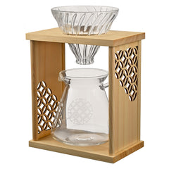 Natural wood drip stand with glass carafe and cone dripper, showing interlocking circle pattern on sides.