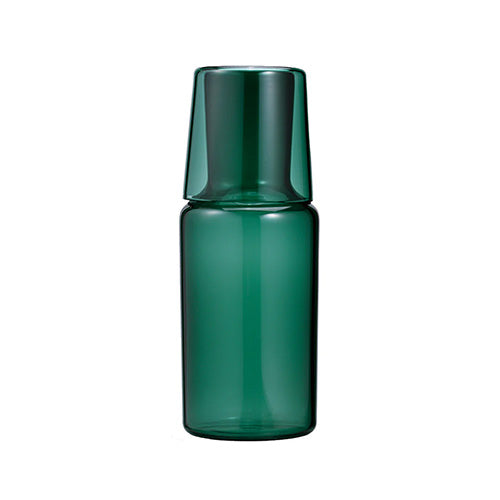 Dark green glass carafe with inverted cup lid shown in front view against white.
