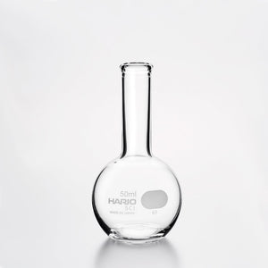 Empty Hario flask vase 50ml with narrow neck and round base on neutral background.