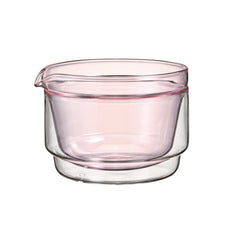 Empty double-walled matcha bowl in pink-tinted glass with clear outer layer.