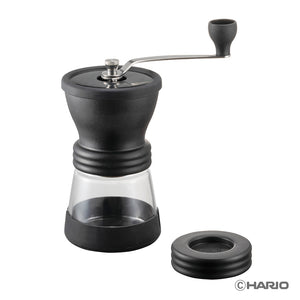 Hario Skerton N ceramic coffee grinder with black burr chamber, glass reservoir, and crank handle.