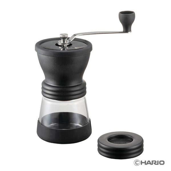 Hario Skerton N ceramic coffee grinder with black burr chamber, glass reservoir, and crank handle.