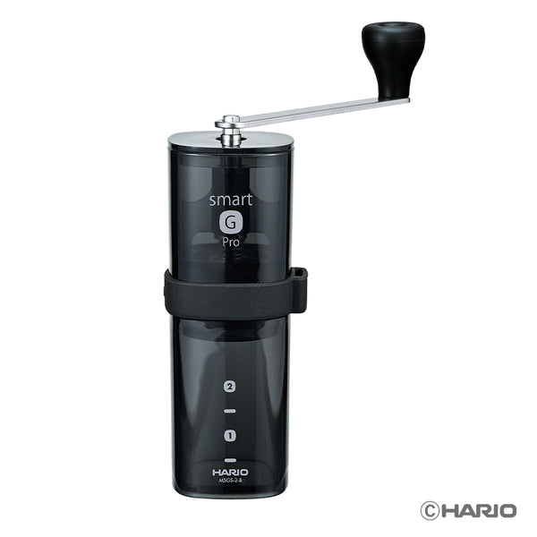 Close-up front view of black Hario Smart G Pro coffee mill with hand crank handle extended.
