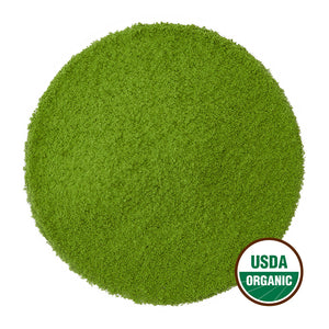 Bright green matcha powder in perfectly round pile with USDA Organic seal.