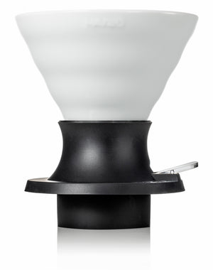 White ceramic V60 dripper with black base and handle shown as standalone product against white background.