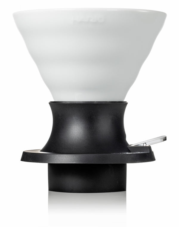 White ceramic V60 dripper with black base and handle shown as standalone product against white background.