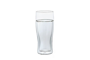 Double-walled glass beer glass half-filled with water on white background
