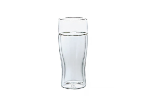 Double-walled glass beer glass half-filled with water on white background