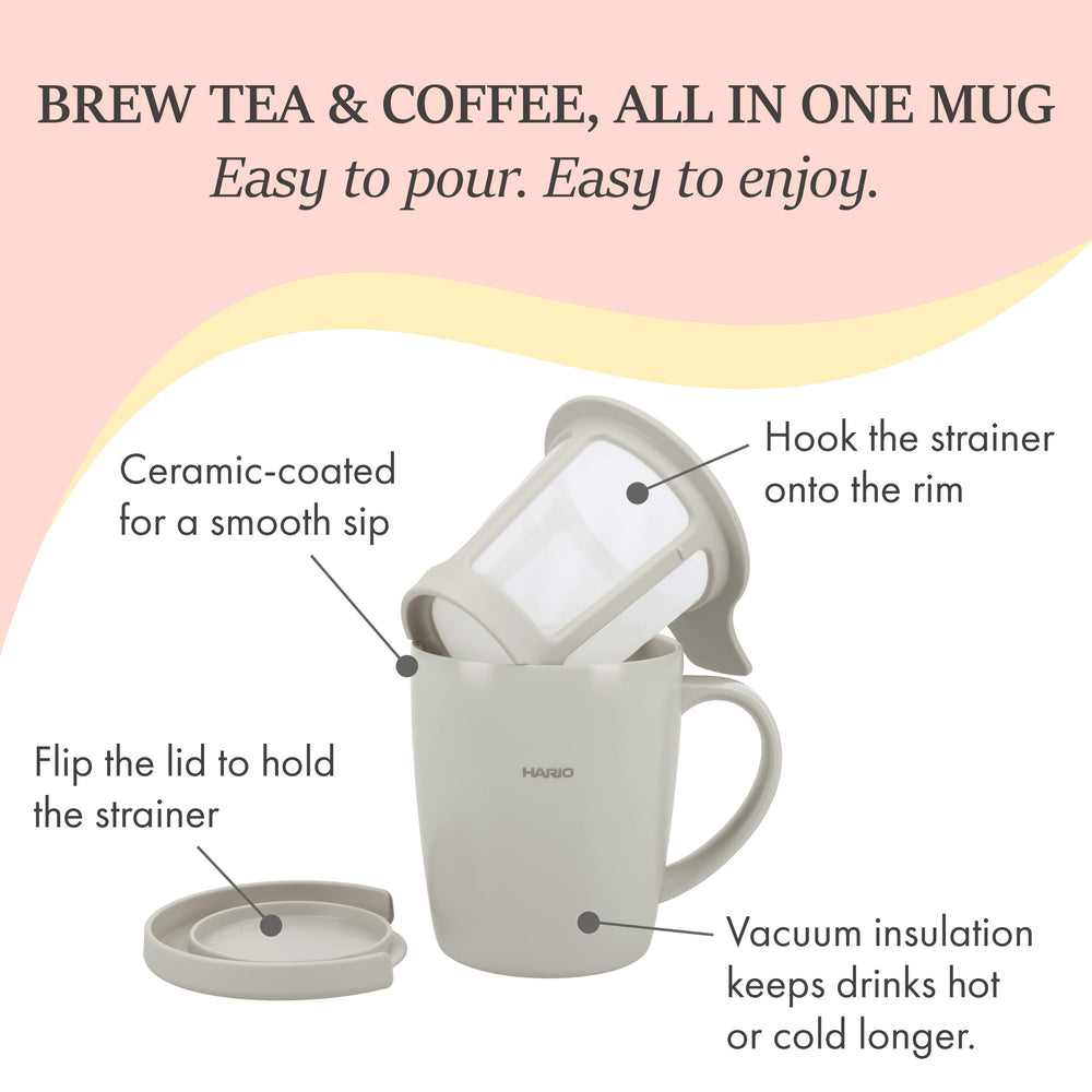 White ceramic mug filled with black coffee on wooden table with mesh filter infuser in background