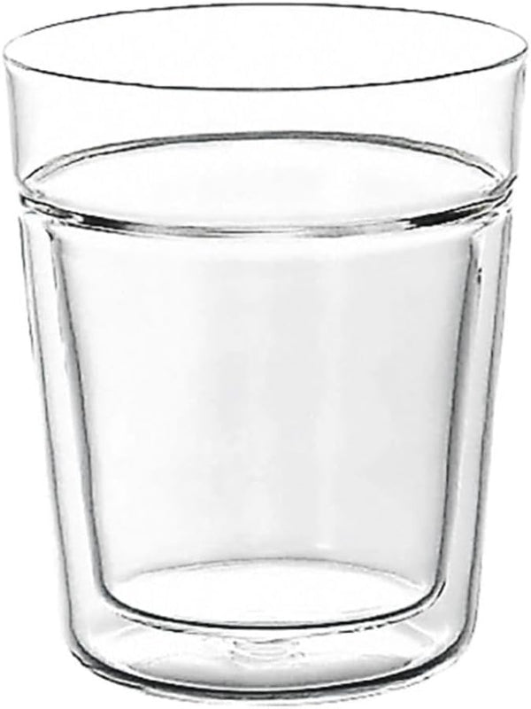 Empty double-walled glass with clear liquid filled to midway mark.
