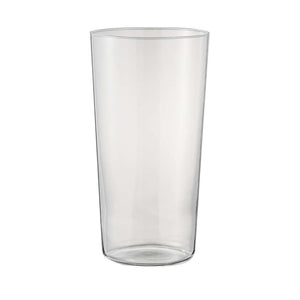 Empty thin-walled cylindrical glass with wider body on white background.