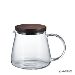 Clear glass coffee server with dark walnut wood lid and metal band, featuring a handle and pour spout.