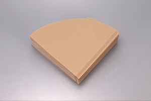 Stack of unfolded white V60 paper filters viewed from above.