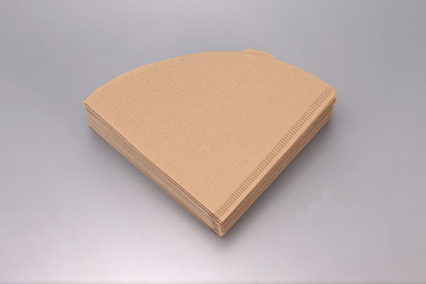 Stack of unfolded white V60 paper filters viewed from above.