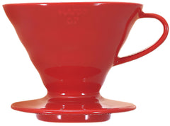 Bright red ceramic V60 02 dripper with glossy finish, wide conical cup, and pedestal base