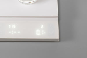 Close-up of white Polaris scale display panel showing time, weight, and control icons