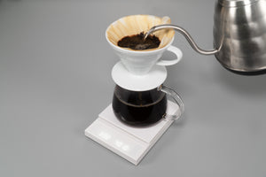 Polaris coffee scale showing completed pour-over brewing process with full carafe