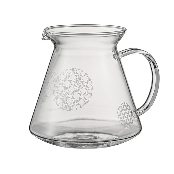 Empty glass server with etched Shippou pattern circles and pouring spout on white background