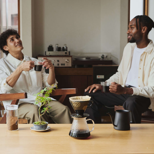 Two people enjoying coffee together using V60 dripper brewing setup