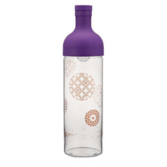 Purple-capped tall glass tea bottle featuring geometric circular mandala patterns on clear glass.