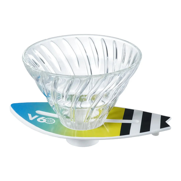 V60 dripper on turquoise-to-lime surfboard base with black and white stripe accents.