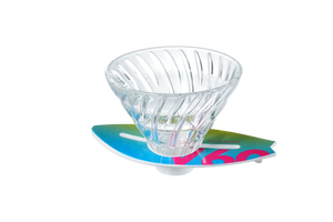 V60 dripper on turquoise-to-magenta surfboard base, compact overhead view.
