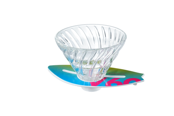 V60 dripper on turquoise-to-magenta surfboard base, compact overhead view.